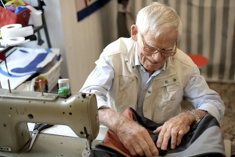 A resident at the sewing machine in the workshop