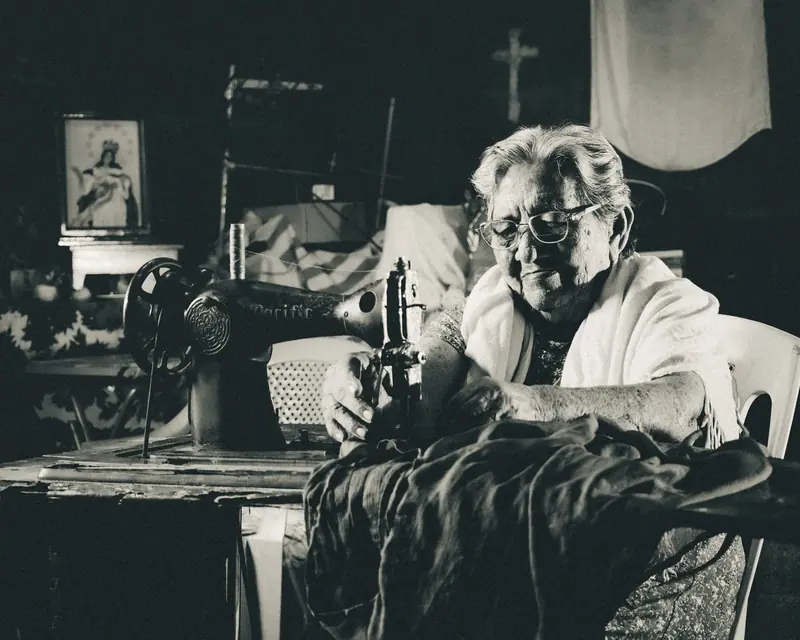 A resident at work in the sewing room
