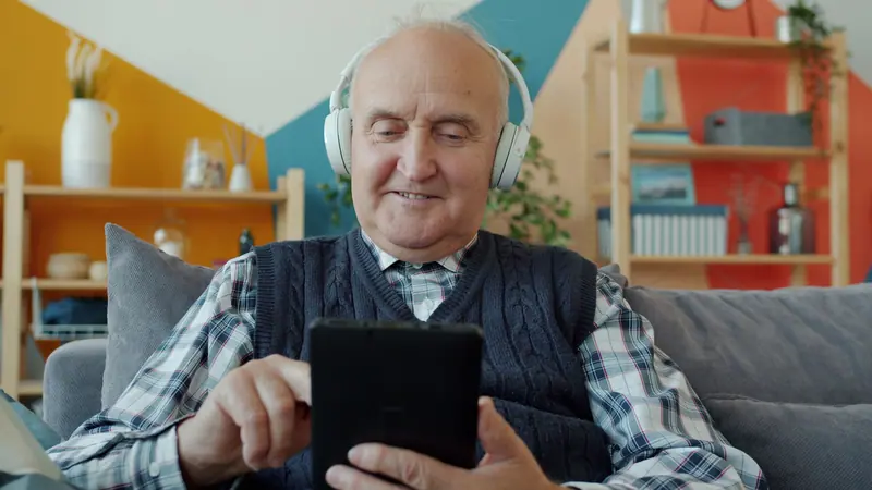 A resident listening to music on his tablet