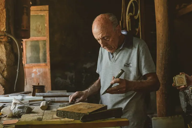 A resident carving wood in the workshop