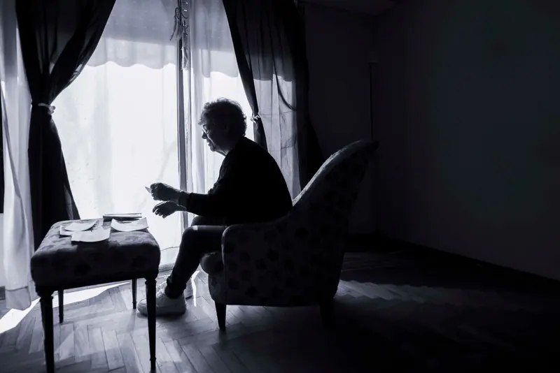 A resident sitting in the quiet room by the window