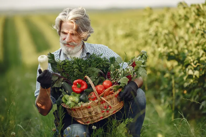 A resident with a basket of fresh vegetables