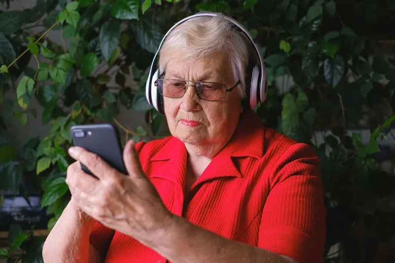 A resident listening to a voice message from her son