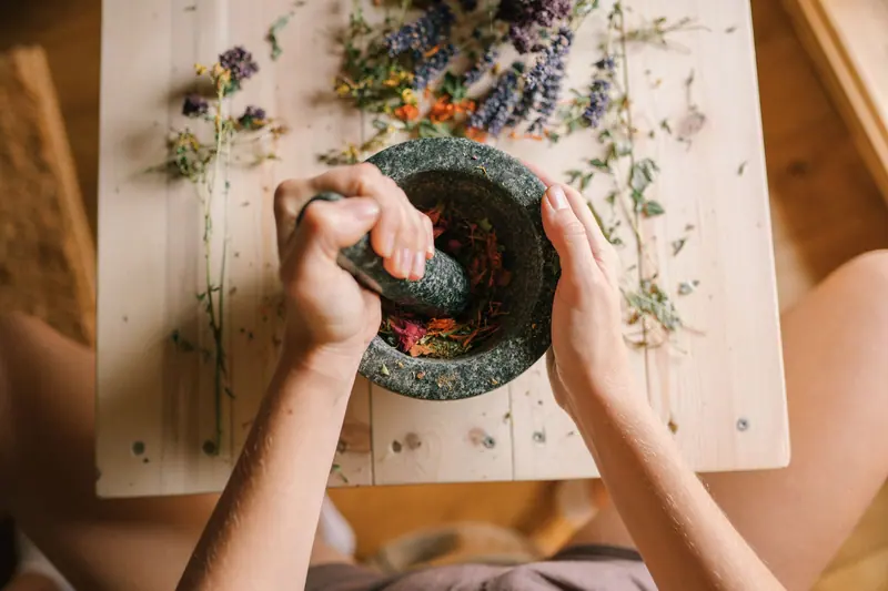 Dried herbs being ground for sachets