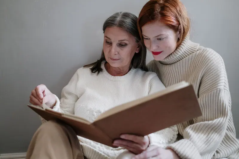 A resident and her daughter reading together