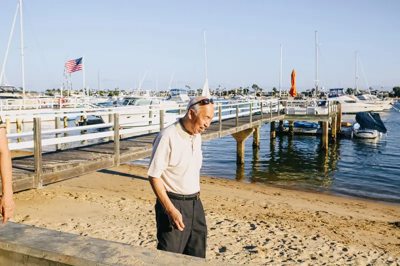 A resident walking the beach by the boat dock