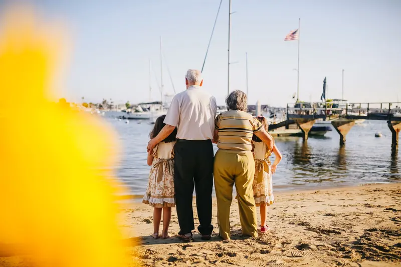 Grandparents and grandchildren looking out at the harbor