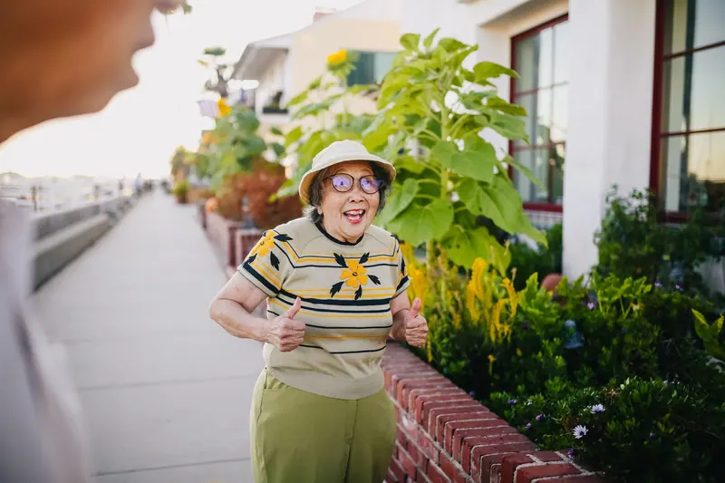 A resident walking past the summer flower boxes
