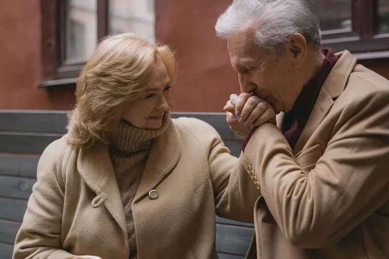 A resident kissing his wife's hand