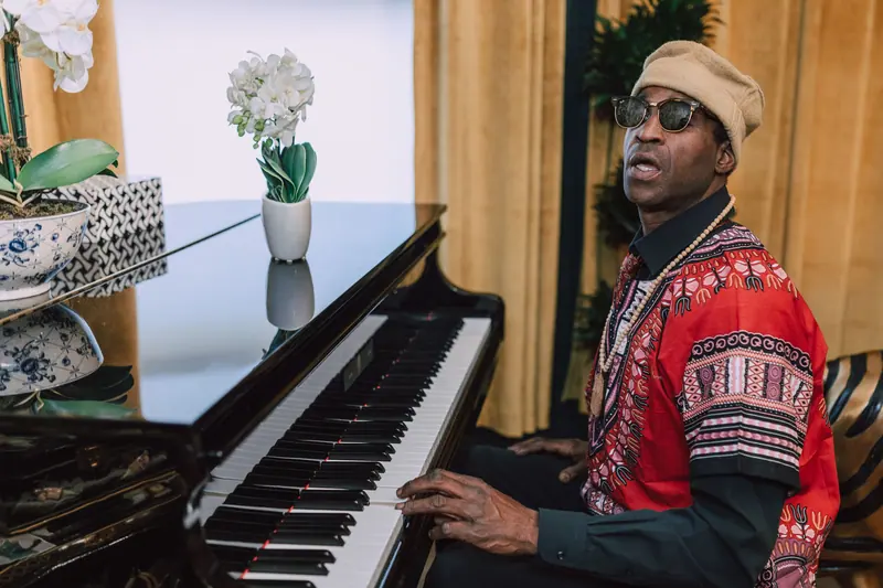 A resident playing the piano in the Welcome Cottage