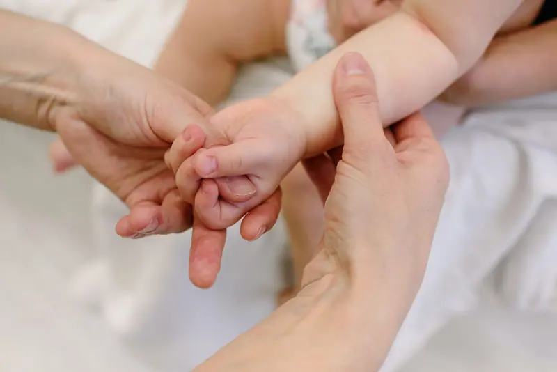 Hands being massaged with lotion