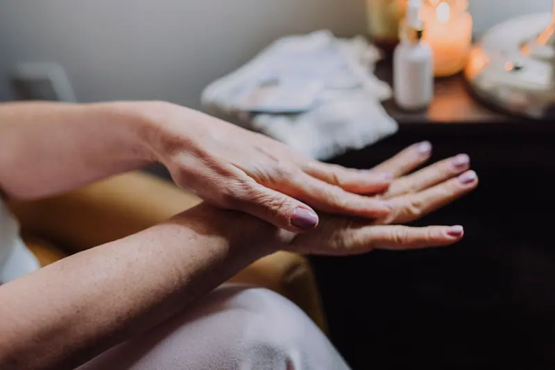 Lotion being smoothed onto a resident's hands