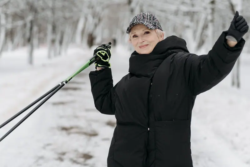 A resident waving her walking pole on the winter path