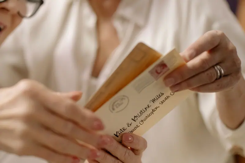 A resident opening an envelope from her granddaughter