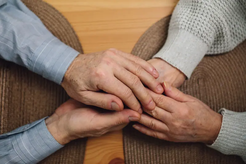 Hands joined across the kitchen table