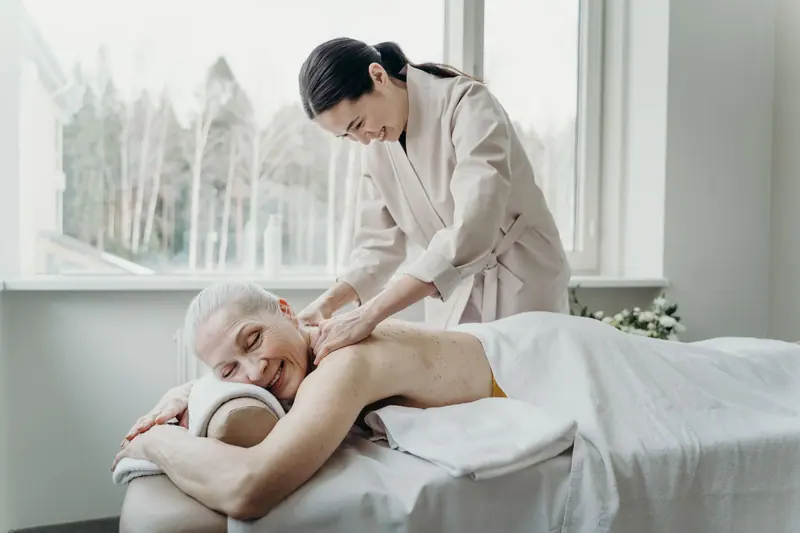 The massage therapist at work by the window
