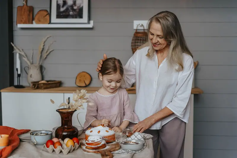 A resident decorating Easter eggs with her granddaughter