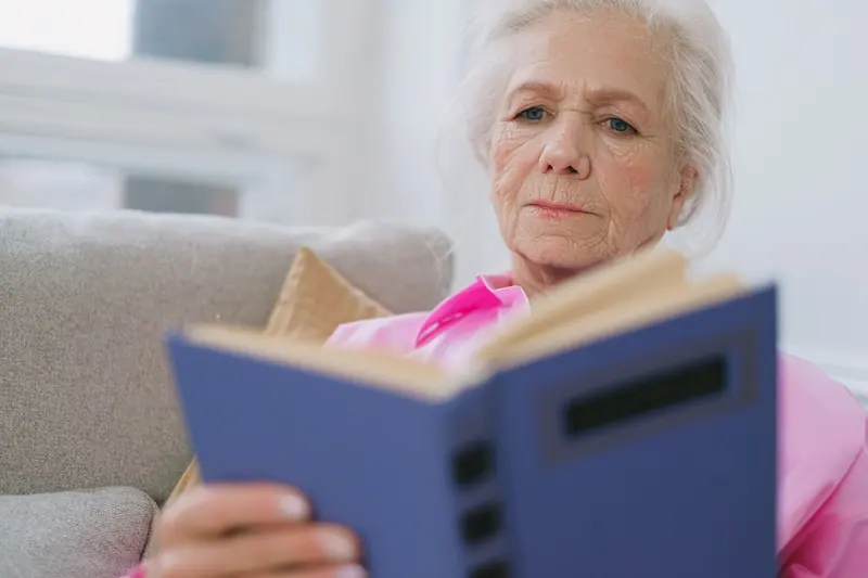 A resident reading on the sofa