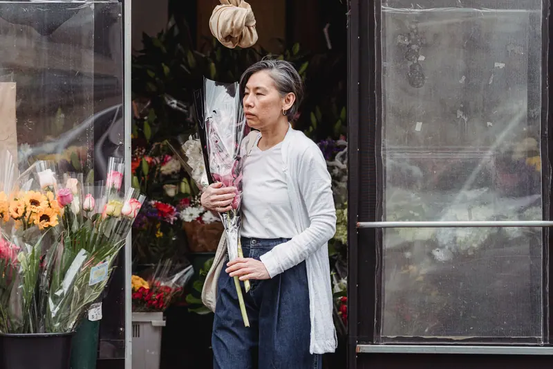 A resident with an armful of tulips outside the flower shop