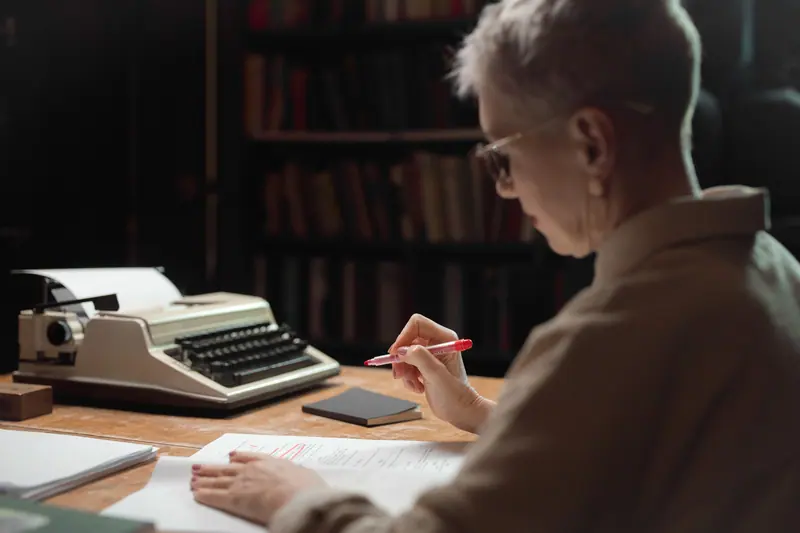 A resident writing beside the old typewriter in the library