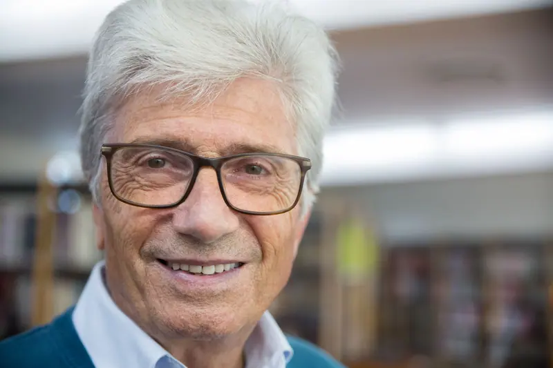 Portrait of a resident with silver hair and glasses