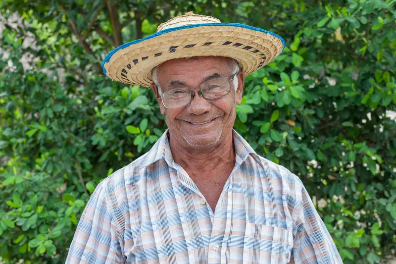 A resident in a straw hat in the garden