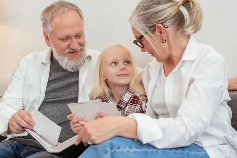 A resident and caregiver sharing a picture book with a preschooler