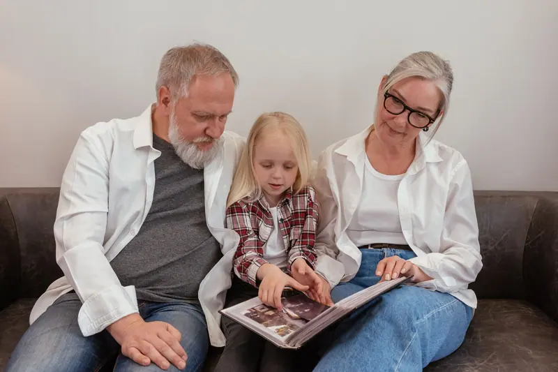A resident couple reading a picture book with a little girl