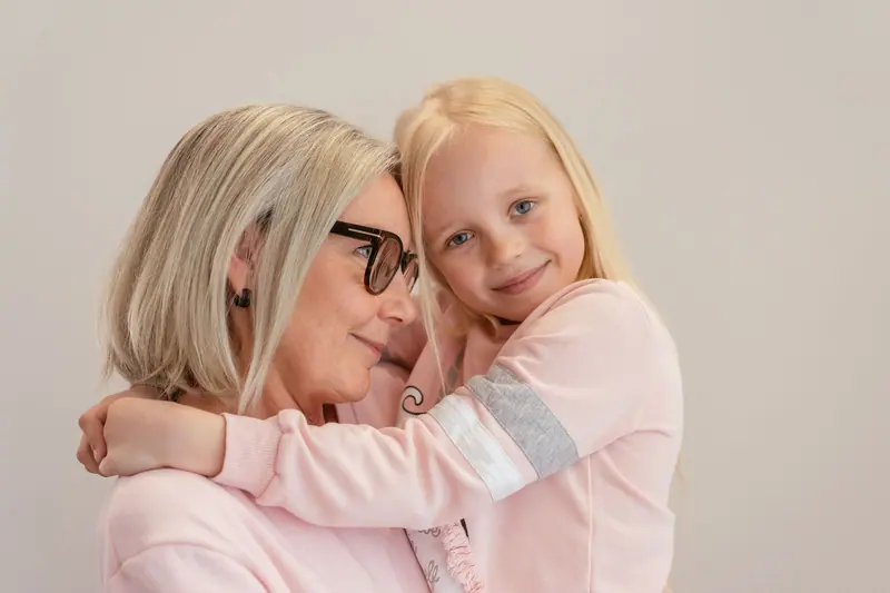 A resident and her granddaughter in a warm embrace