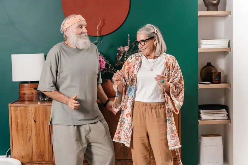 A resident couple laughing in their room