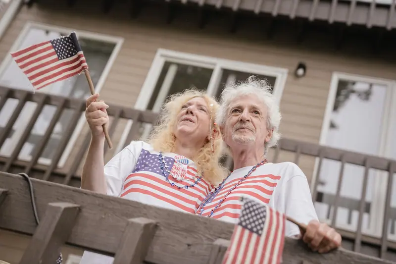 Two residents in flag shirts on the porch