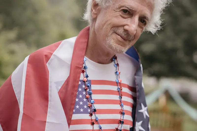 A resident wrapped in a flag, smiling for the camera on the Fourth of July