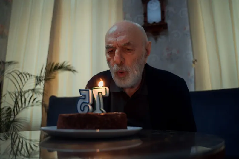 A resident blowing out his birthday candles