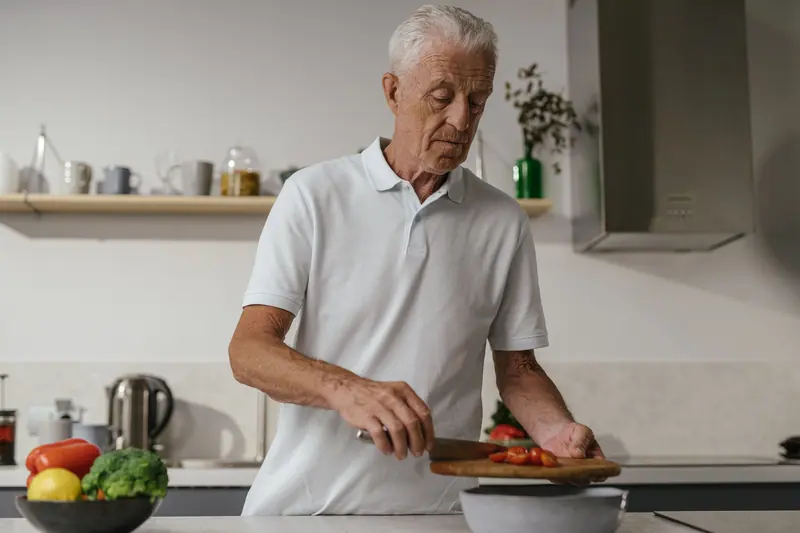 A resident slicing vegetables for dinner