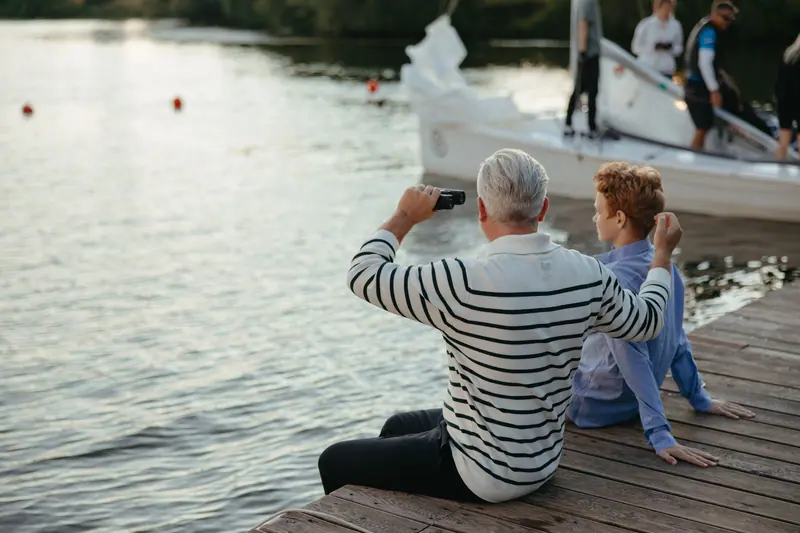 A resident and his grandson sitting on the dock