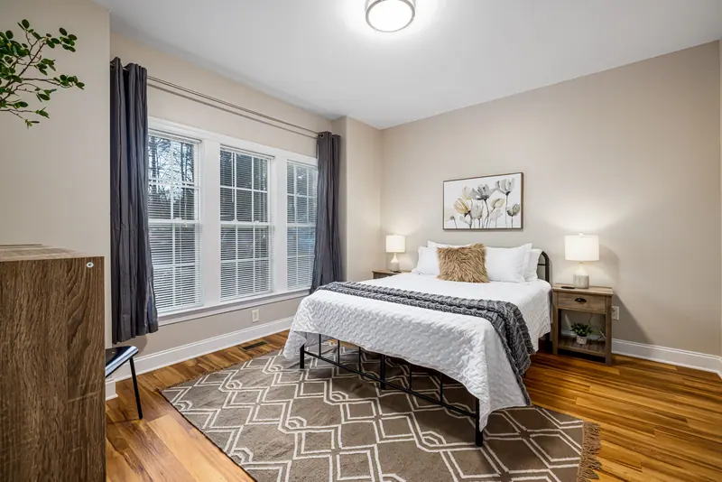 Bright bedroom decorated in modern style with natural light and cozy accents.