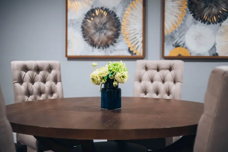 A round table set with flowers in the dining room