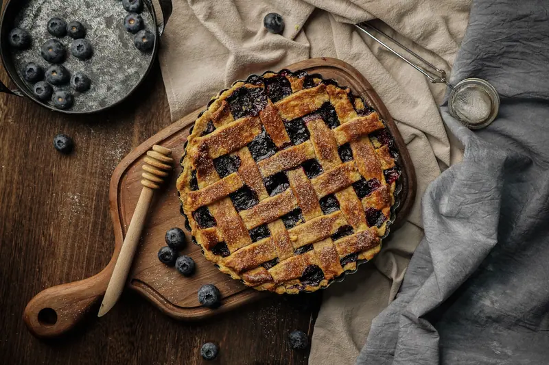 A blueberry lattice pie on the kitchen table