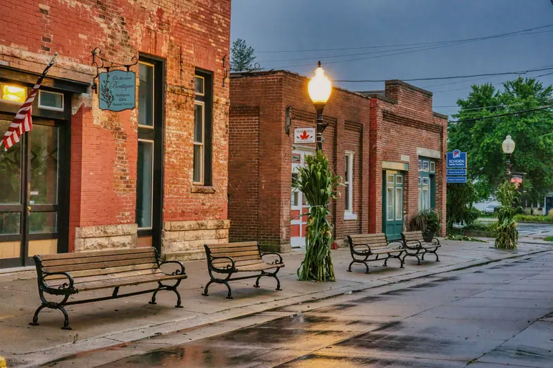 Brick storefronts and benches on a nearby street