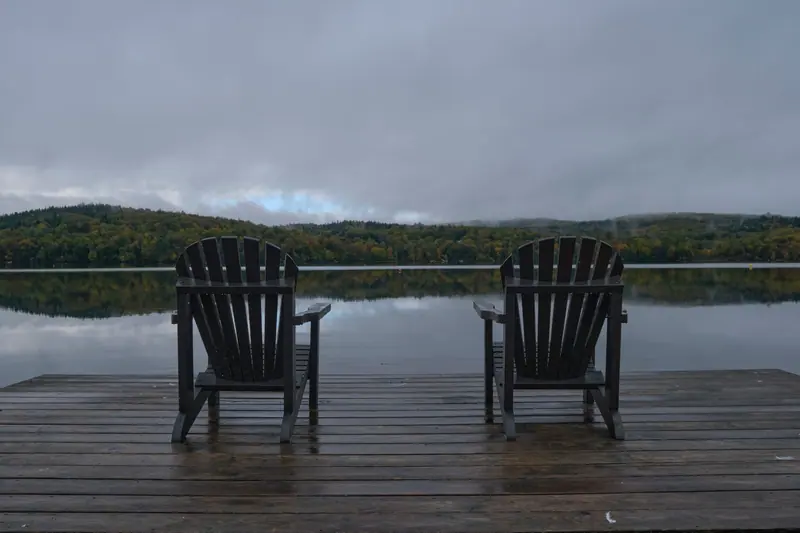 Two Adirondack chairs waiting on the dock
