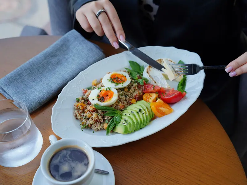 Eggs, avocado and coffee at breakfast