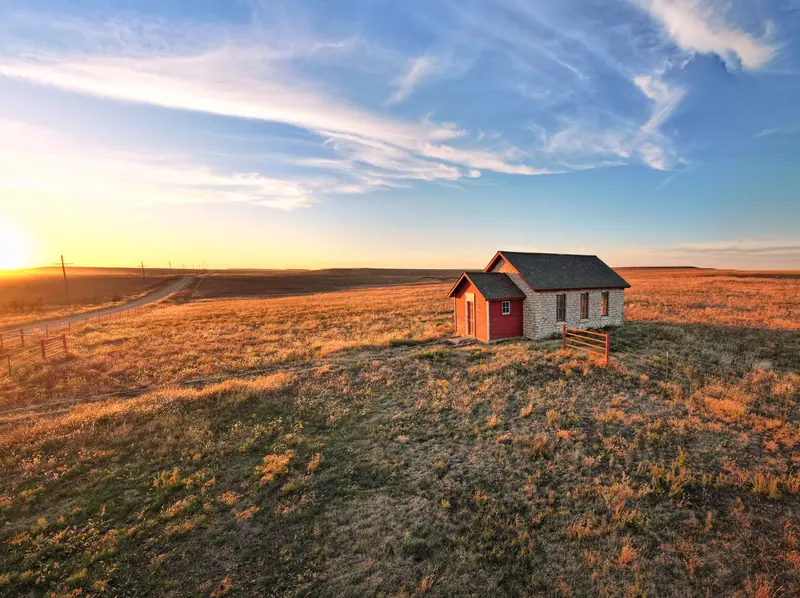 A small homestead on the Kansas plains at golden hour