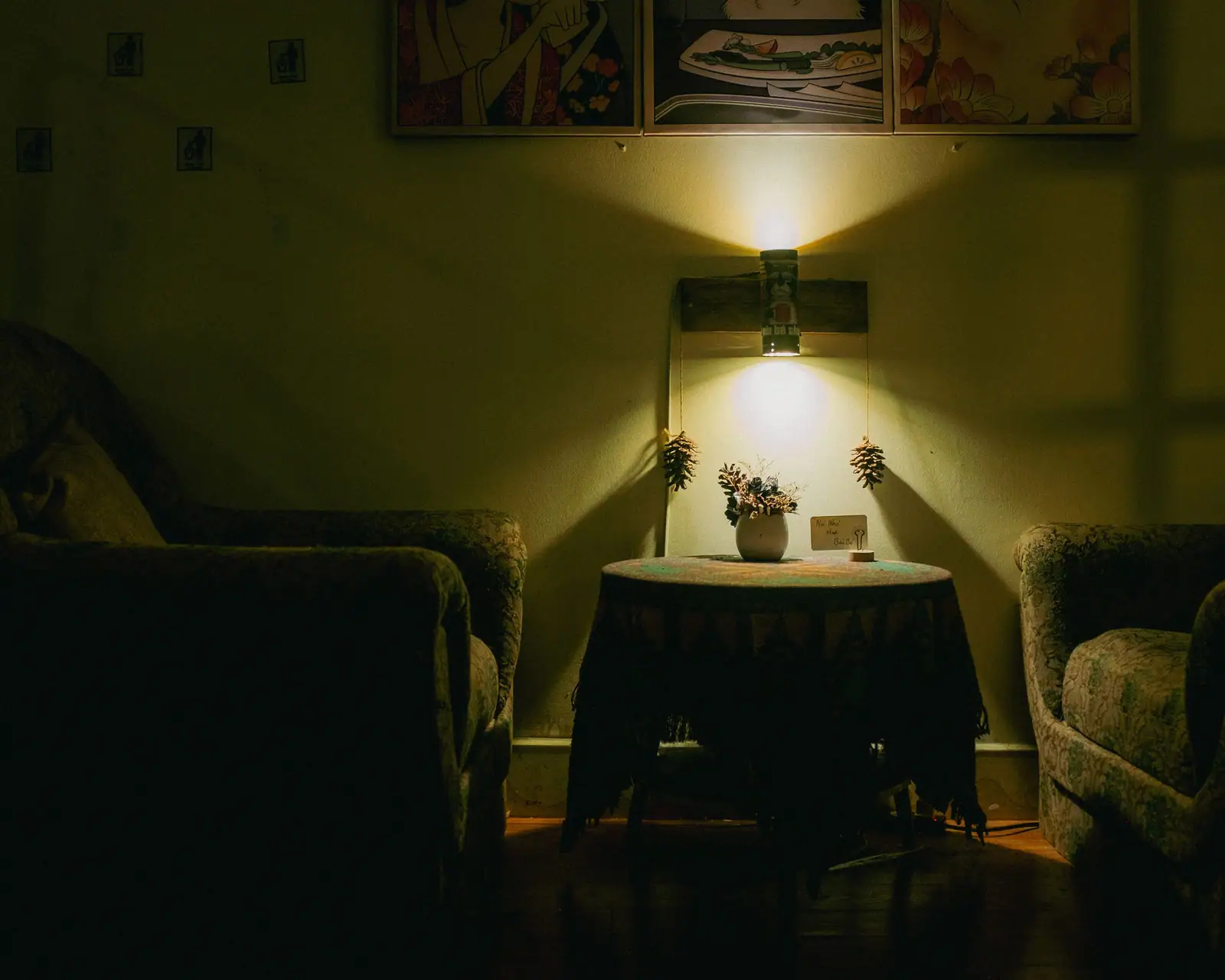 A lamp-lit sitting room with armchairs and a small table