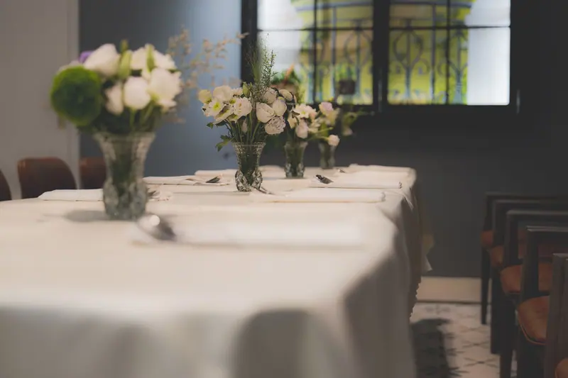White linen and fresh flowers in the dining room