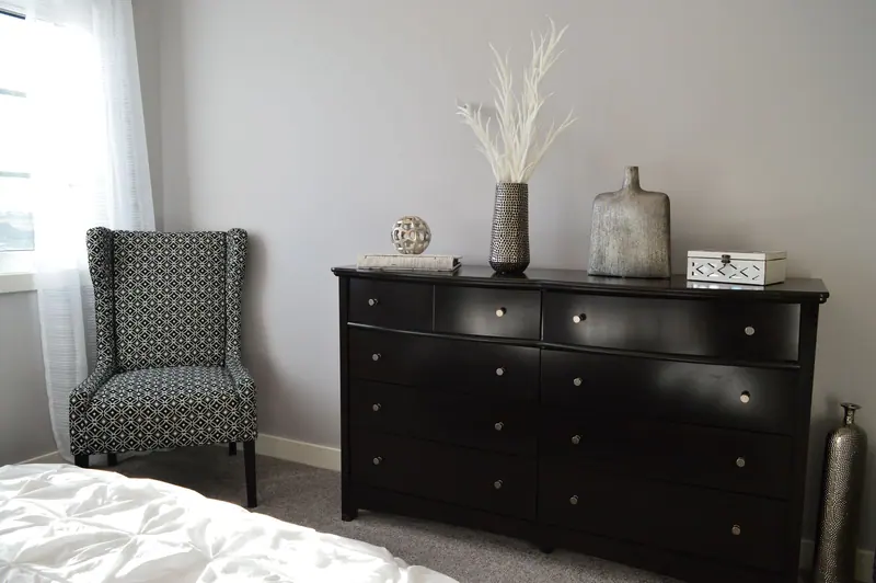Sleek and stylish bedroom with modern black furniture and elegant decor.