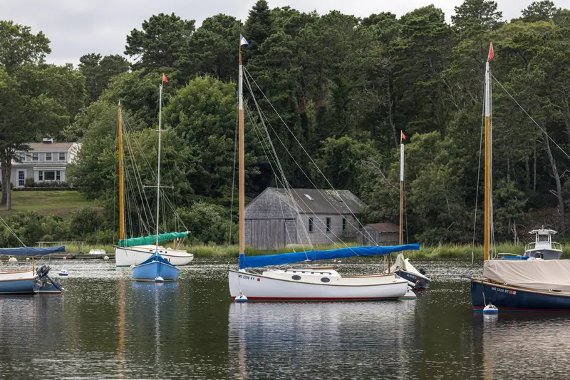 Sailboats moored in the cove below the cottages