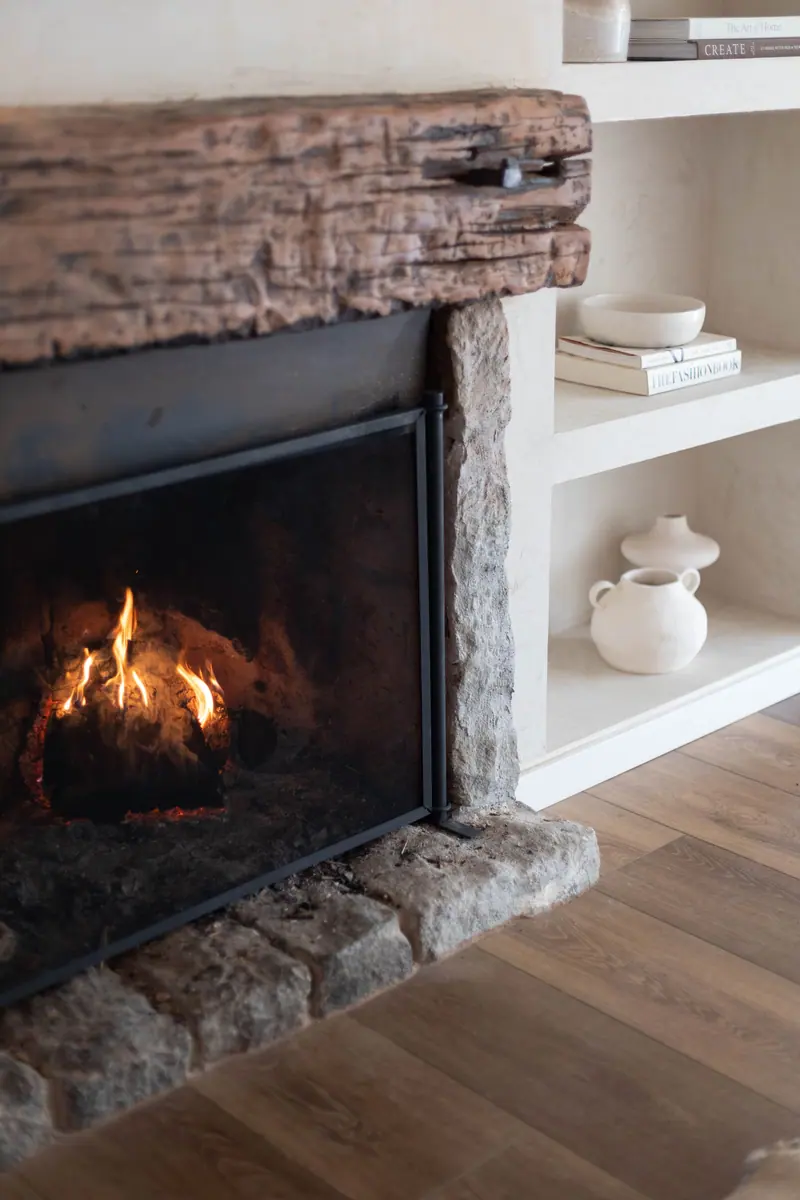 A stone fireplace in the parlor