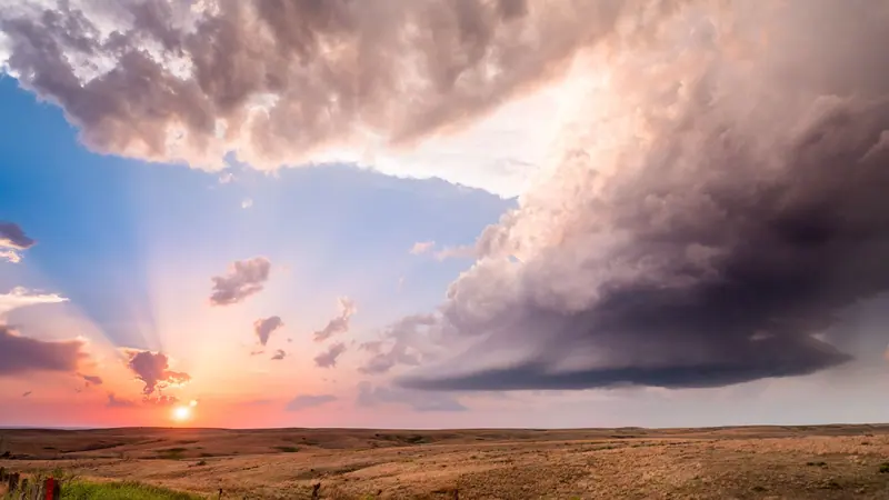 A storm building over the Kansas prairie at sunset