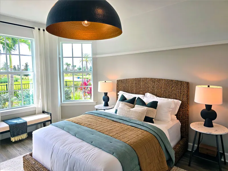 A beautifully designed bedroom featuring modern decor with natural light and an outdoor view.