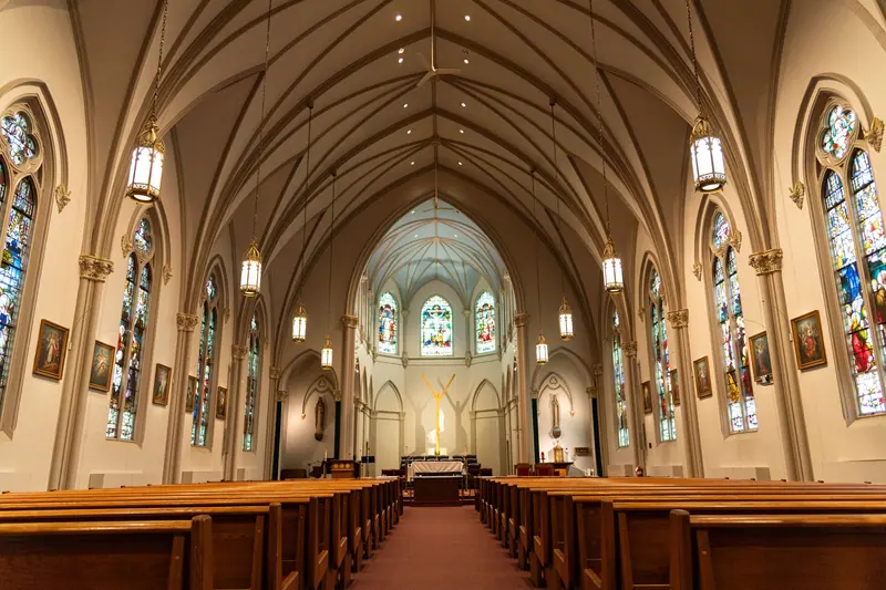The sanctuary of a church with stained-glass windows